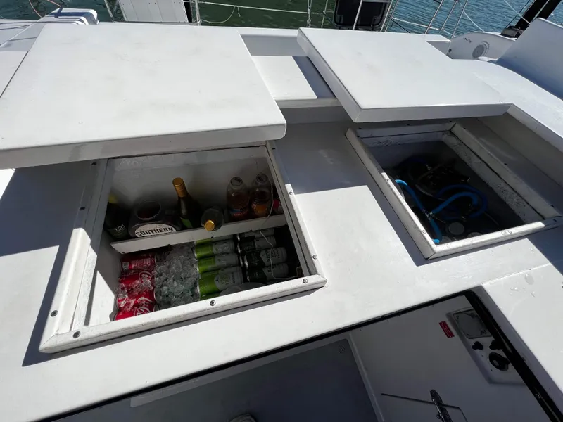 Slide: The Image of Built-in storage compartments on a 1992 Robertson Custom Catamaran, stocked with beverages and equipment. - 39