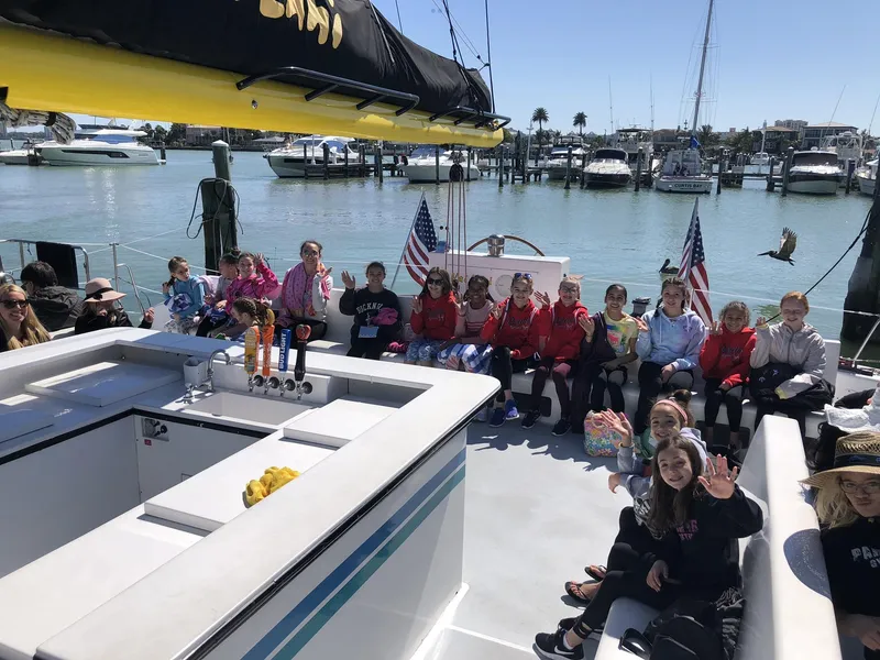 Slide: The Image of Group of children on a 1992 Robertson Custom Catamaran Sloop Rig, docked at a marina. - 4