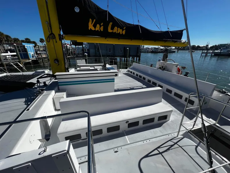Slide: The Image of 1992 Robertson Custom Catamaran Sloop Rig docked, featuring spacious deck and seating area. - 42