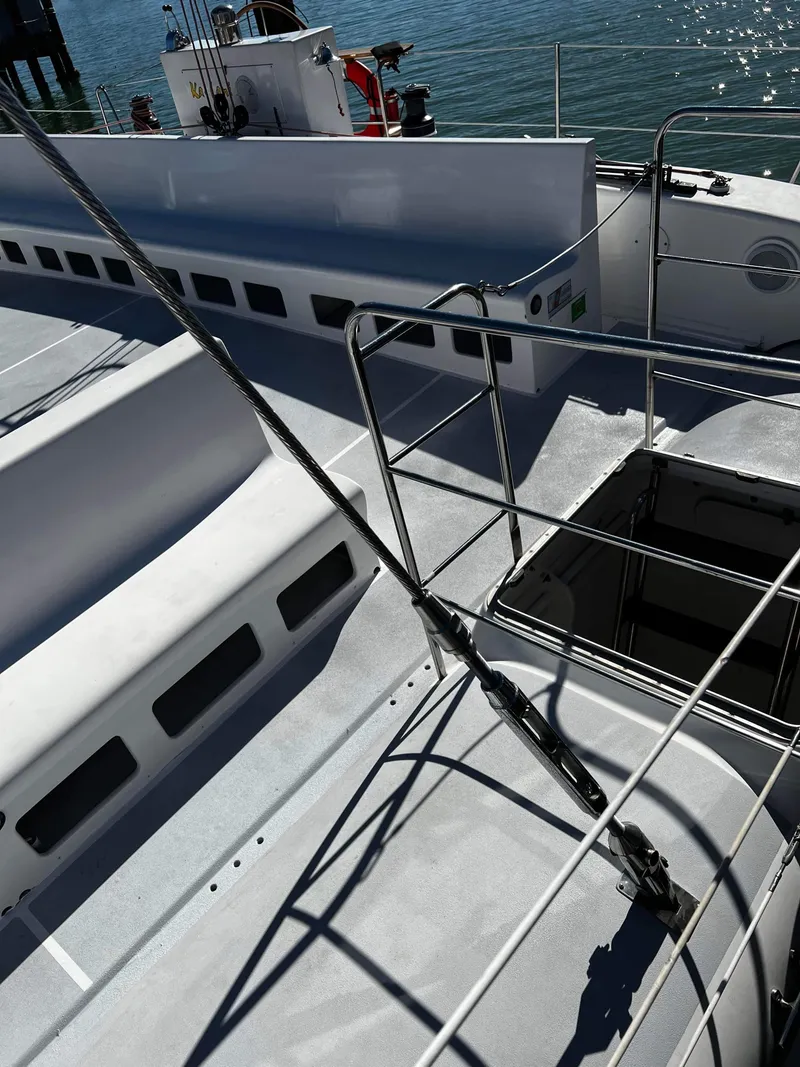 Slide: The Image of Deck view of a 1992 Robertson Custom Catamaran / Sloop Rig in a marina. - 46