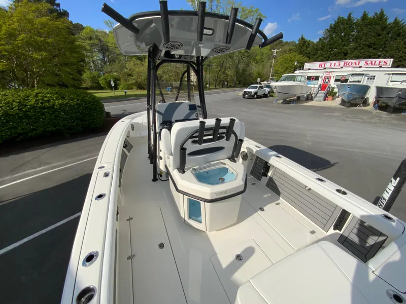 Slide: The Image of 2024 Pathfinder 2400 Open boat at a dealership, showcasing the deck and seating area. - 12
