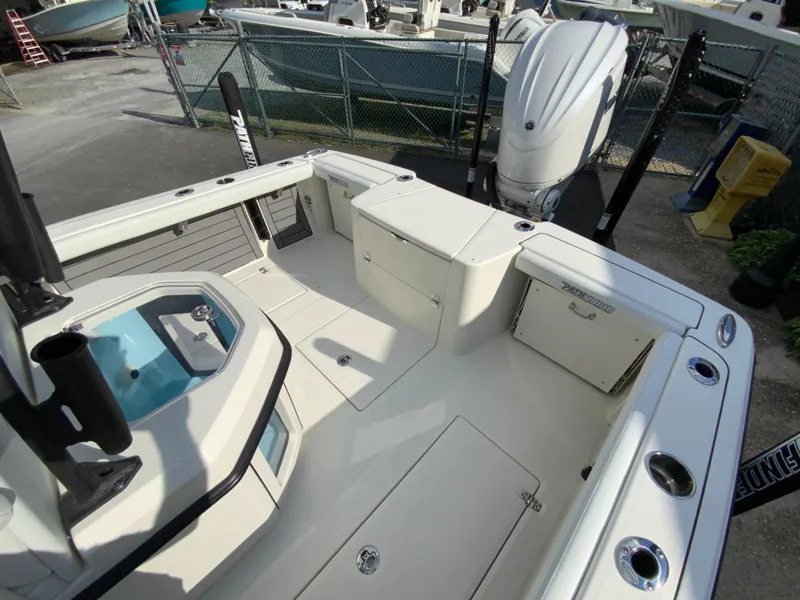 Slide: The Image of 2024 Pathfinder 2400 Open boat deck with storage compartments and outboard motor. - 18