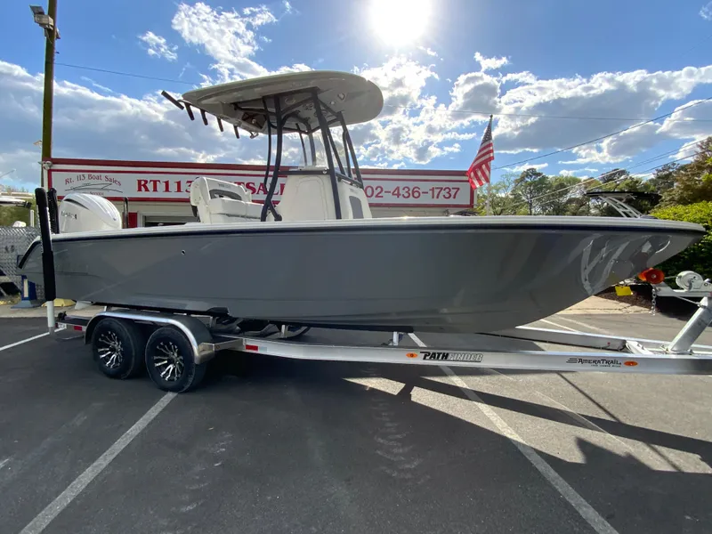 Slide: The Image of 2024 Pathfinder 2400 Open boat on trailer in dealership lot. - 2