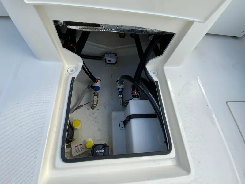 Slide: The Image of 2024 Pathfinder 2400 Open boat storage compartment with wiring and components. - 36