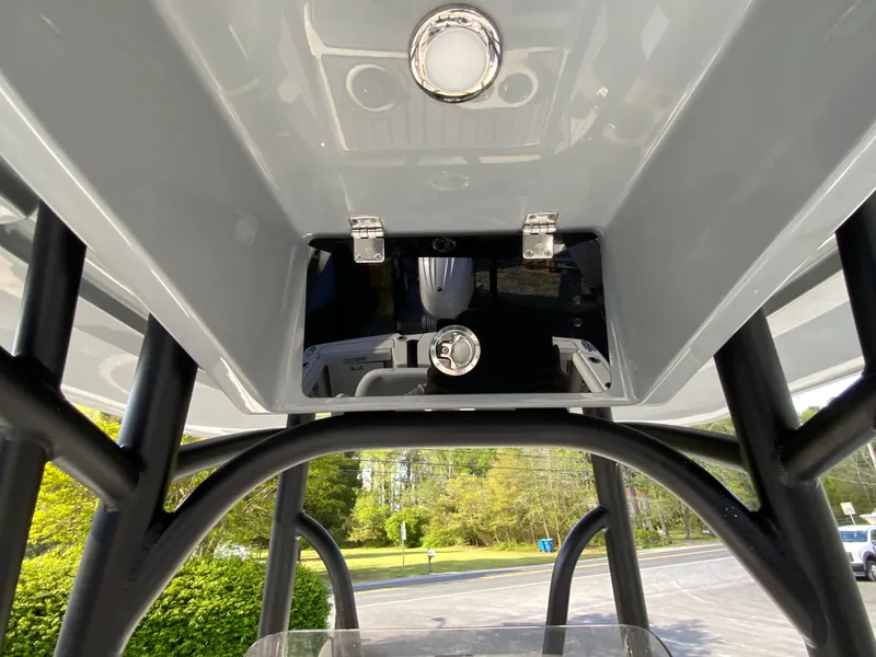 Slide: The Image of 2024 Pathfinder 2400 Open T-top storage compartment and rod holders. - 38