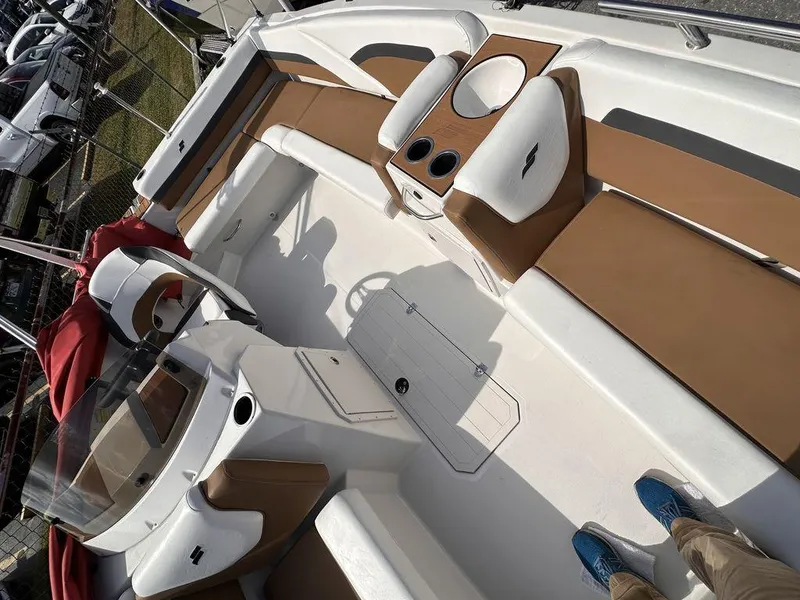 Slide: The Image of 2023 Starcraft SVX OB 191 OB boat interior with tan and white seating. - 10