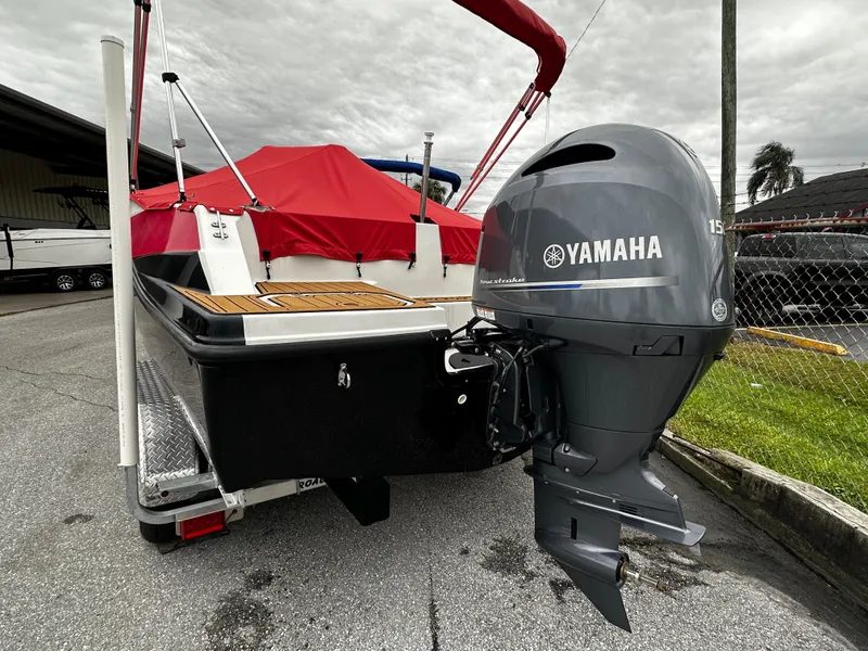 Slide: The Image of 2023 Starcraft SVX OB 191 with Yamaha outboard motor, red cover, parked outdoors. - 4