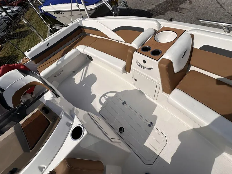 Slide: The Image of 2023 Starcraft SVX OB 191 OB boat interior with tan and white seating. - 8