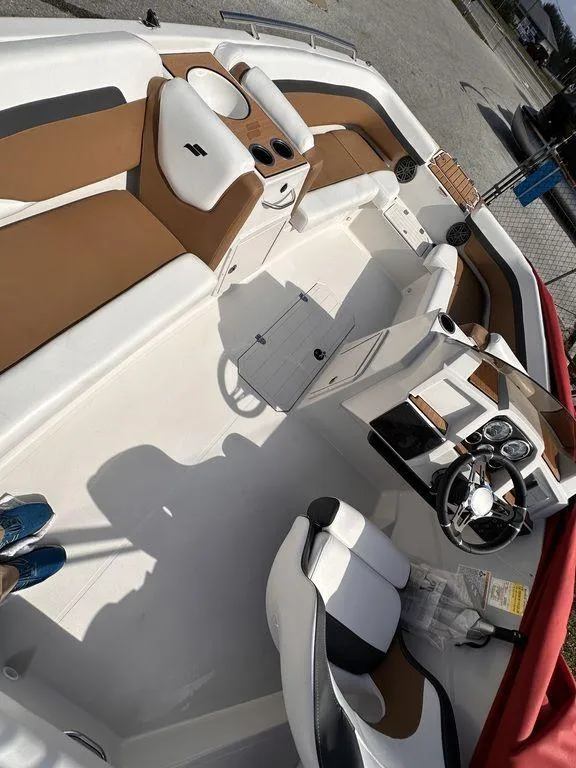 Slide: The Image of 2023 Starcraft SVX OB 191 OB boat interior with tan and white seating. - 9