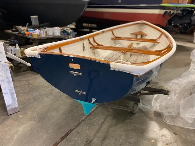Slide: The Image of 1973 Stanley Herreshoff Yacht Tender in a workshop, showcasing classic wooden design. - 3