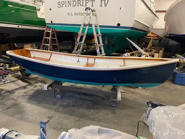 Slide: The Image of 1973 Stanley Herreshoff Yacht Tender in a workshop, blue hull, wooden interior. - 6