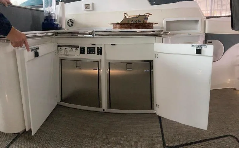 Slide: The Image of 2018 Cobalt A40 Coupe yacht kitchen with open cabinets and stainless steel appliances. - 12