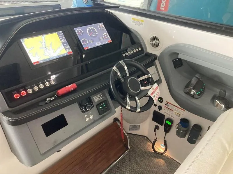 Slide: The Image of 2018 Cobalt A40 Coupe boat dashboard with navigation screens and steering wheel. - 4