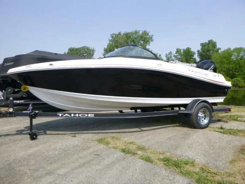 Slide: The Image of 2023 Tahoe 200 S boat on trailer, black and white design, parked outdoors. - 1