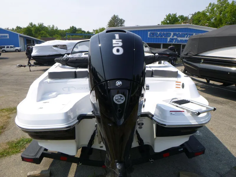 Slide: The Image of 2023 Tahoe 200 S boat with 150 HP engine at dealership. - 3