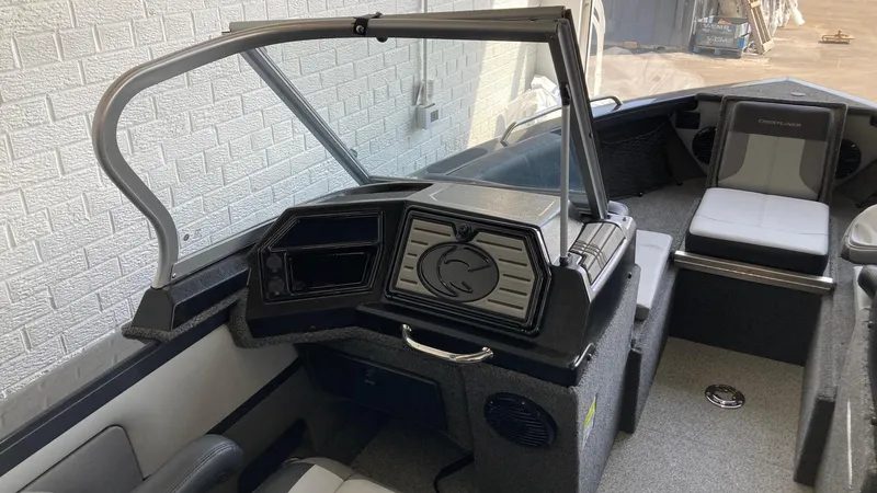Slide: The Image of 2024 Crestliner 2050 Sportfish boat interior with steering console and seating. - 5