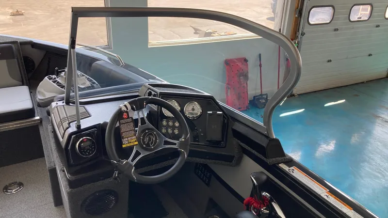 Slide: The Image of 2024 Crestliner 2050 Sportfish boat interior, steering wheel, and control panel. - 6