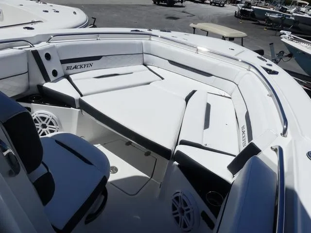 Slide: The Image of 2022 Blackfin 252CC boat interior with white seating and branded cushions. - 10