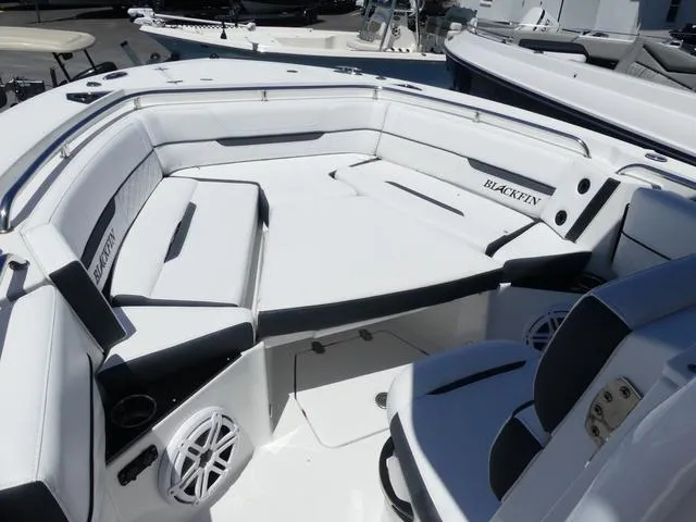 Slide: The Image of 2022 Blackfin 252CC boat interior with white seating and speaker system. - 11