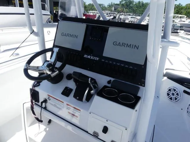 Slide: The Image of 2022 Blackfin 252CC boat dashboard with Garmin displays and steering wheel. - 14