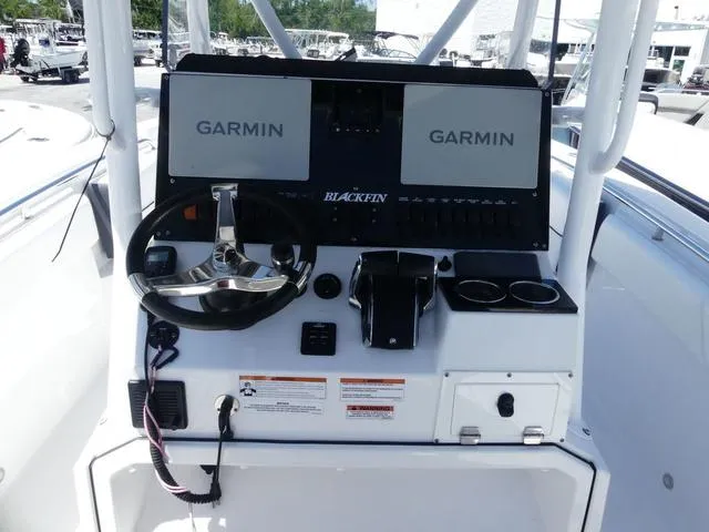 Slide: The Image of 2022 Blackfin 252CC boat console with dual Garmin displays and steering wheel. - 15