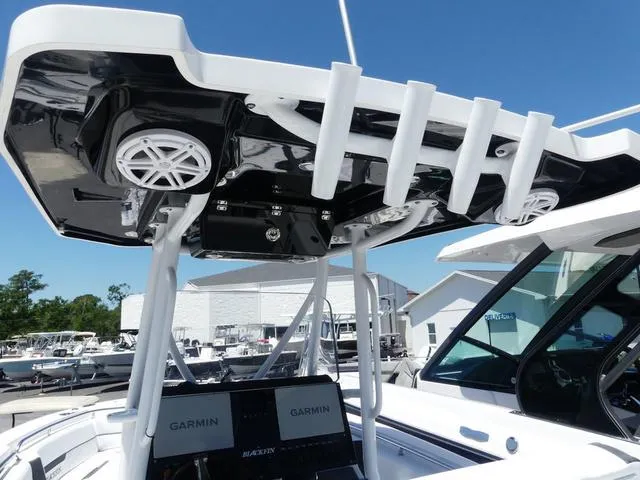 Slide: The Image of 2022 Blackfin 252CC boat with Garmin electronics and rod holders, docked under clear blue sky. - 17