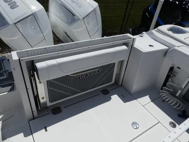Slide: The Image of 2022 Blackfin 252CC boat deck with seating and dual outboard engines. - 8