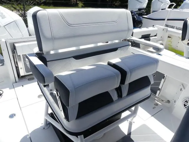 Slide: The Image of 2022 Blackfin 252CC boat seating with dual cushioned seats and armrests. - 9