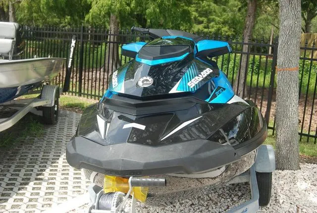 Slide: The Image of 2018 Sea-Doo Waverunner GTR in blue and black, parked on a trailer. - 3