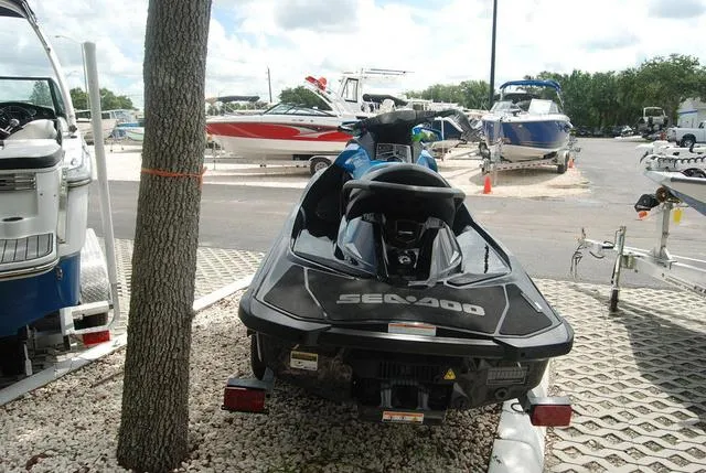 Slide: The Image of 2018 Sea-Doo Waverunner GTR parked at a marina with boats in the background. - 4
