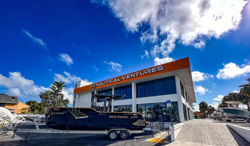 Slide: The Image of X Shore Eelex 8000 electric boat outside Nautical Ventures dealership, 2023 model. - 8