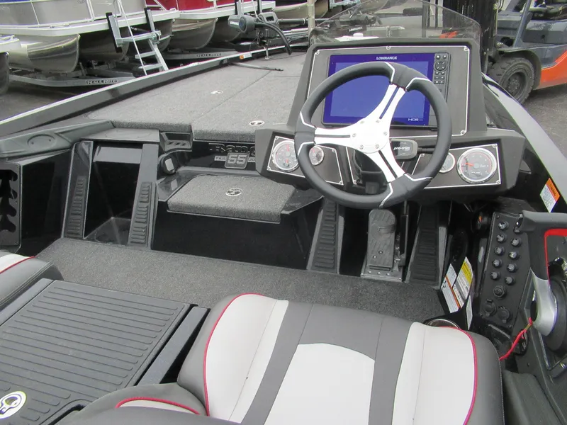 Slide: The Image of 2023 Ranger Z518 boat cockpit with steering wheel and navigation display. - 2