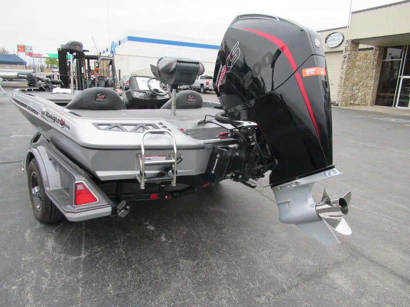 Slide: The Image of 2023 Ranger Z518 boat with powerful outboard motor, parked on a trailer. - 5