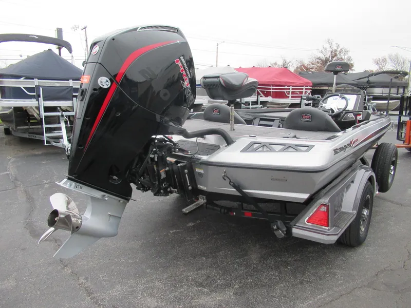 Slide: The Image of 2023 Ranger Z518 boat with powerful outboard motor, parked on a trailer. - 6