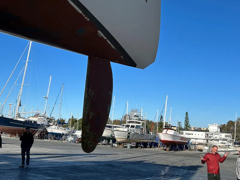 Slide: The Image of 1996 Custom 100' Sailing Yacht in dry dock with other boats in the background. - 18
