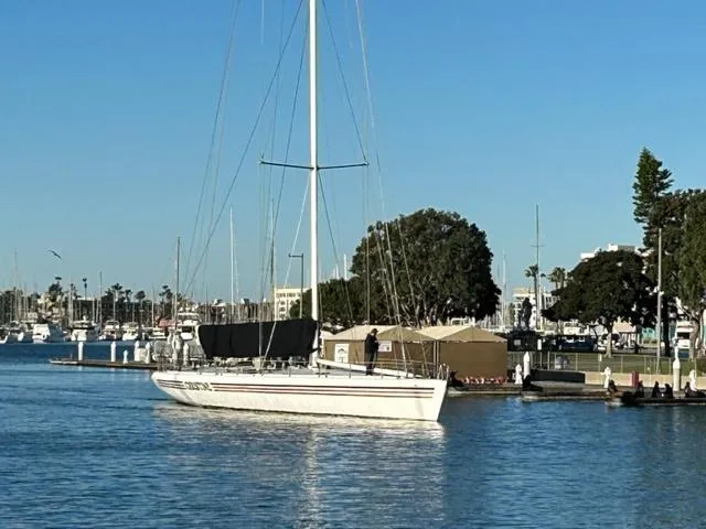 Slide: The Image of Custom 100' Sailing Yacht (1996) docked in a marina with clear blue skies. - 2