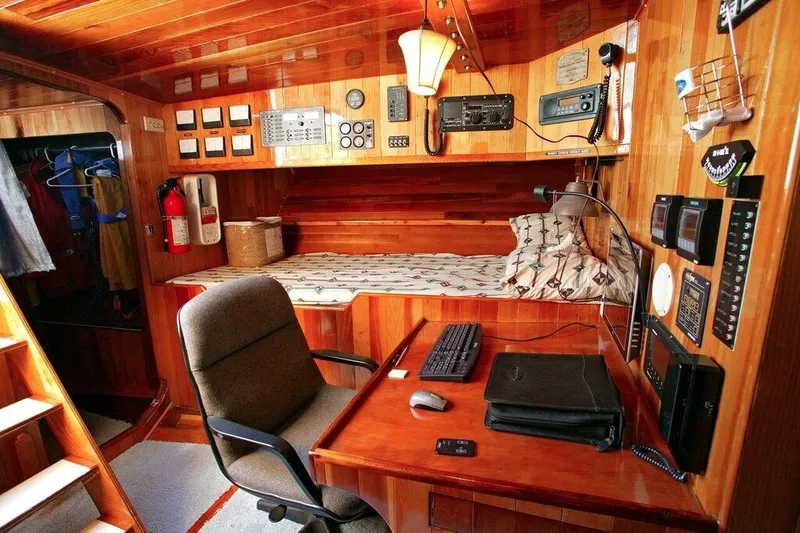 Slide: The Image of 1996 Custom 100' Sailing Yacht interior with navigation desk and cozy sleeping area. - 27