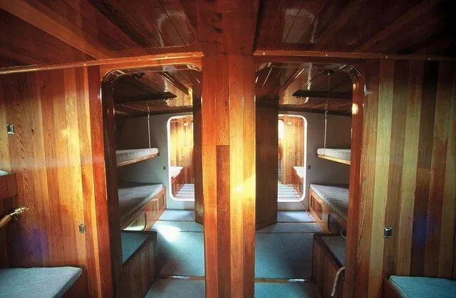 Slide: The Image of Interior of a 1996 Custom 100' Sailing Yacht with wooden bunk beds. - 31