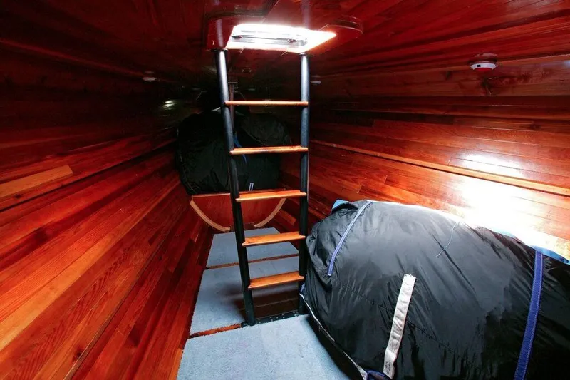 Slide: The Image of Interior of 1996 Custom 100' Sailing Yacht with wooden walls and ladder. - 32