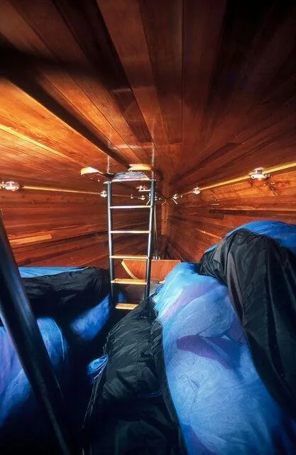 Slide: The Image of Interior cabin of a 1996 Custom 100' Sailing Yacht with wooden walls and ladder. - 36