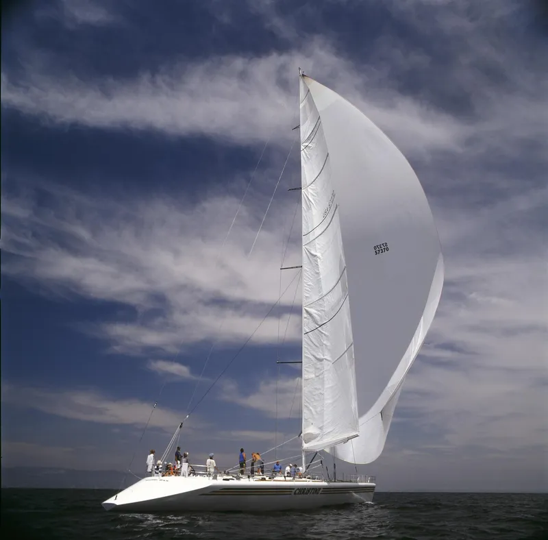 Slide: The Image of Custom 100' sailing yacht from 1996 with large white sails on open water. - 39