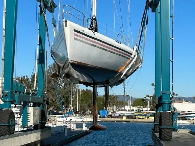 Slide: The Image of Custom 100' Sailing Yacht 1996 being lifted in a marina for maintenance. - 45