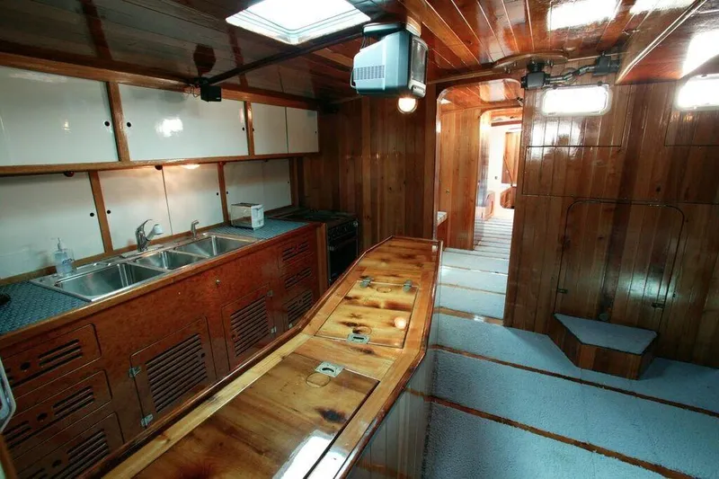 Slide: The Image of Interior of 1996 Custom 100' Sailing Yacht with wooden finishes and modern kitchen. - 6