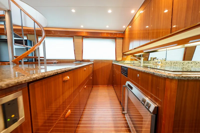 Slide: The Image of Luxurious kitchen interior of 2008 Viking 68 Skybridge yacht with wooden cabinetry and granite countertops. - 11