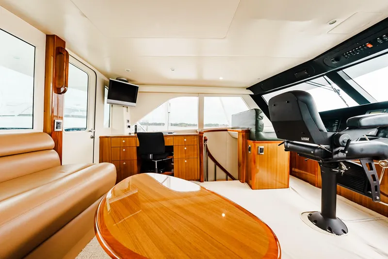 Slide: The Image of Luxurious interior of 2008 Viking 68 Skybridge yacht with leather seating and wooden table. - 45