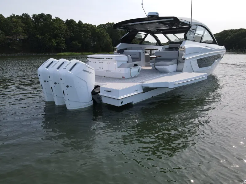 Slide: The Image of 2025 Cruisers Yachts 50 GLS Outboard on water, rear view. - 19