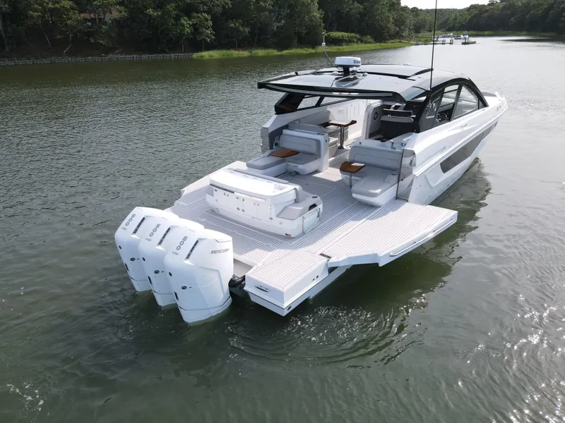 Slide: The Image of 2025 Cruisers Yachts 50 GLS Outboard on a serene lake. - 5