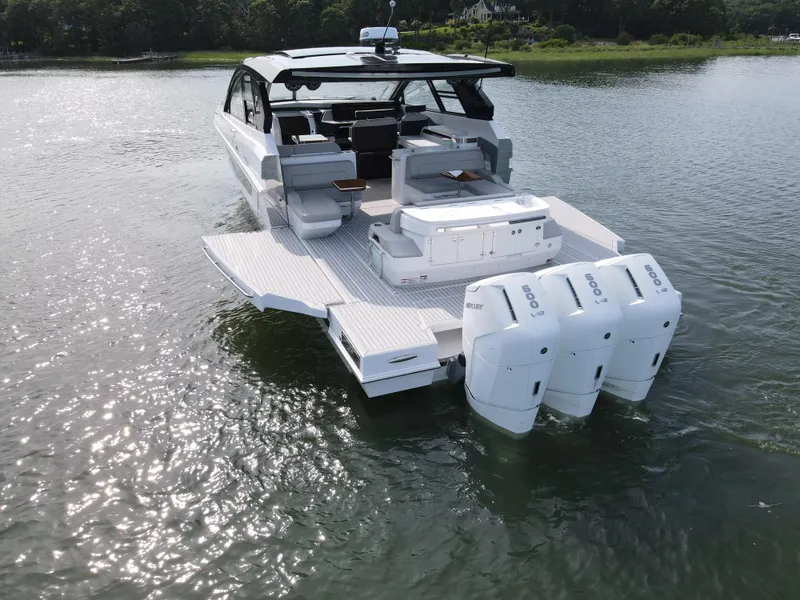 Slide: The Image of 2025 Cruisers Yachts 50 GLS Outboard on water, rear view. - 7