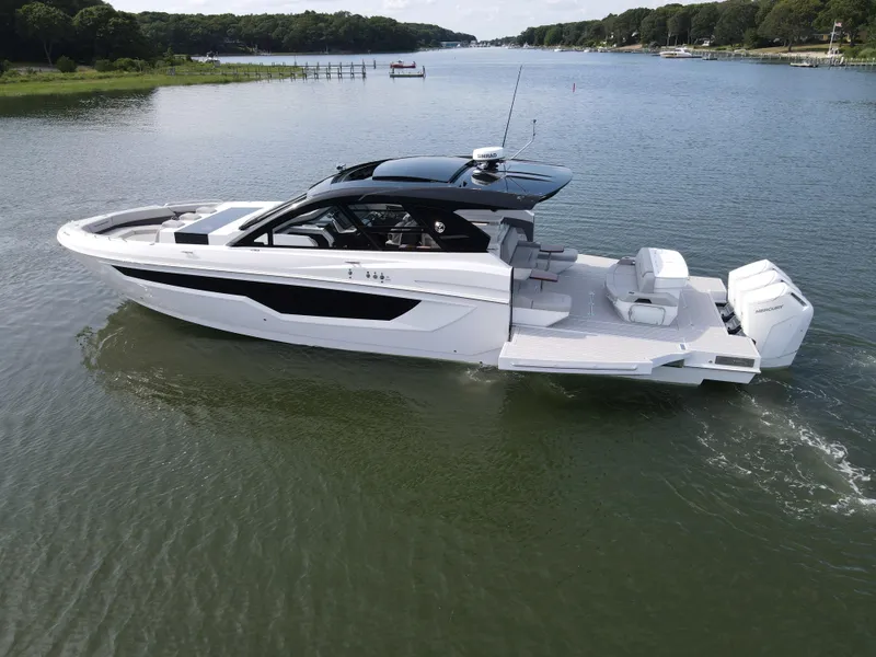 Slide: The Image of 2025 Cruisers Yachts 50 GLS Outboard on a serene lake. - 9