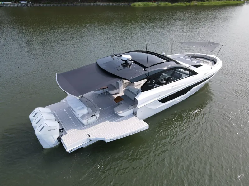 Slide: The Image of 2025 Cruisers Yachts 50 GLS Outboard luxury boat on water. - 25